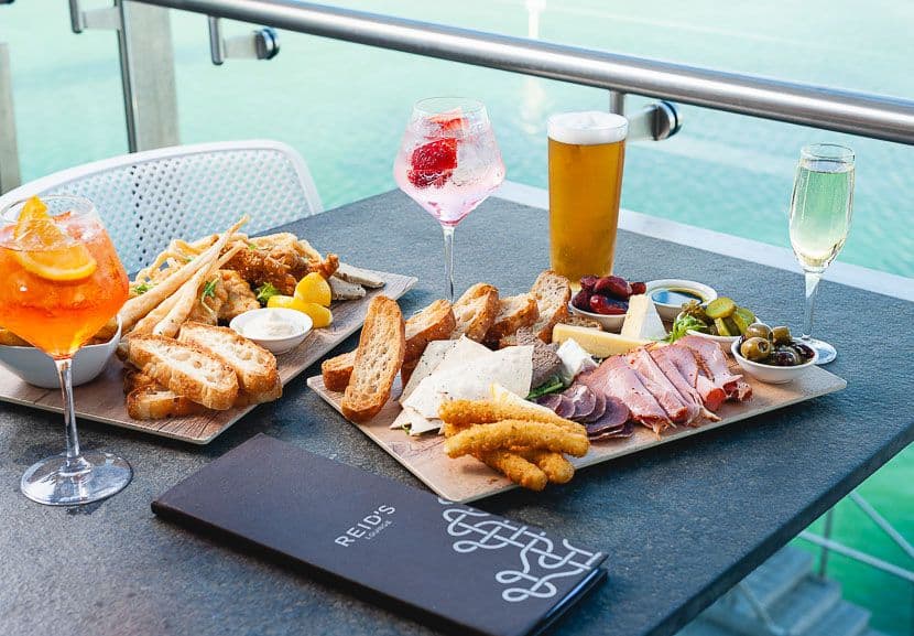 Two platters and various drinks on a table at The Breakwater.