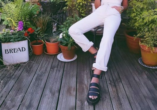 Model showing black sandals from On the Quay footwear.