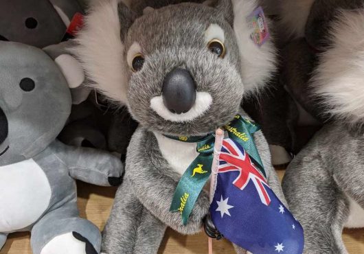 A koala toy holding an Australian flag.